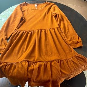 Womens fall colored “orange” dress with long sleeves and flowy bottom. NWT.